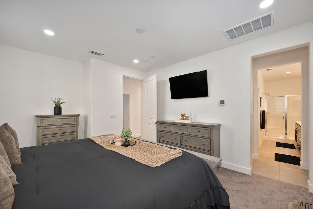 17500 Beachwood Road Lathrop, CA 95330 - Photo 42 of 78 a bedroom with a bed and a flat screen tv