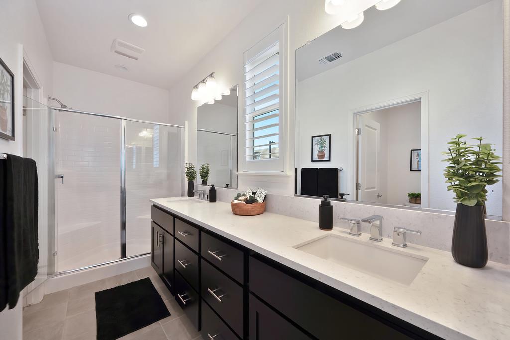 17500 Beachwood Road Lathrop, CA 95330 - Photo 44 of 78 a bathroom with double vanity sinks a vanity and a shower