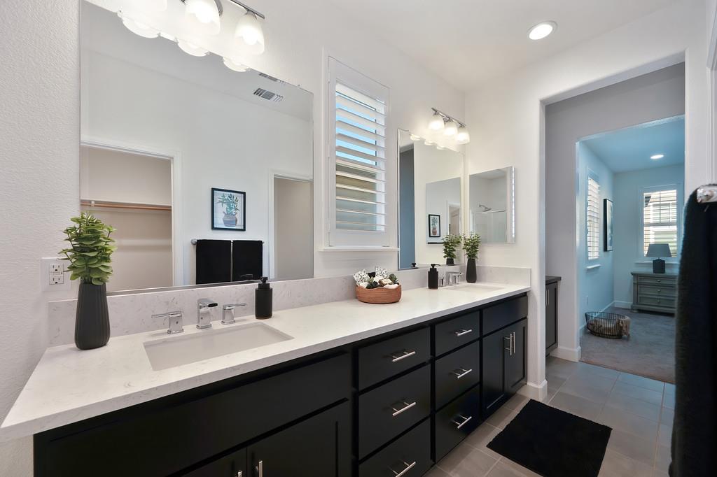 17500 Beachwood Road Lathrop, CA 95330 - Photo 45 of 78 a bathroom with double sink and a mirror