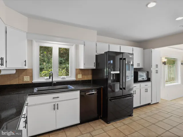 a kitchen with a refrigerator stove and sink