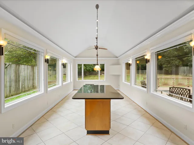 a living room with a large window and chandelier