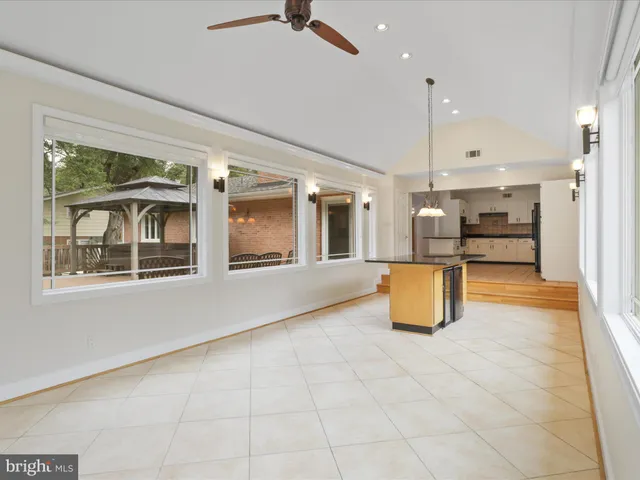 a large kitchen with kitchen island granite countertop lots of counter space and stainless steel appliances