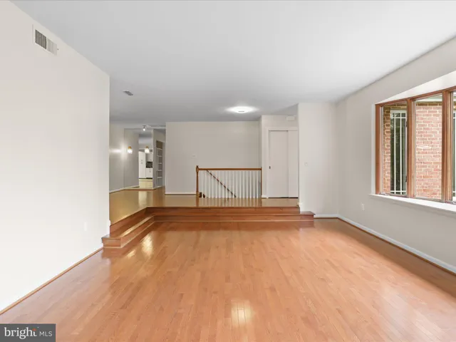 a view of a livingroom with wooden floor and a window