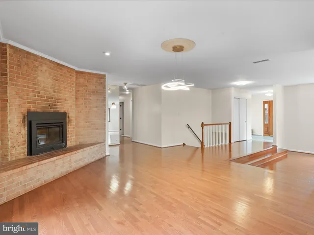 a view of an empty room with a fireplace