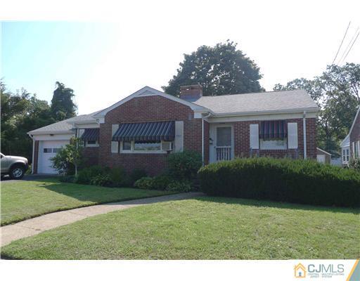 1707 River Road Belmar, NJ 07719 - Photo 1 of 17 a view of a big yard in front of a brick house