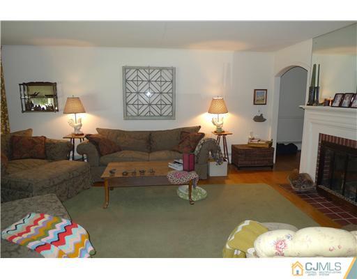 1707 River Road Belmar, NJ 07719 - Photo 3 of 17 a living room with furniture and a fireplace
