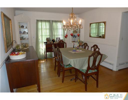 1707 River Road Belmar, NJ 07719 - Photo 4 of 17 a view of a dining room with furniture and chandelier