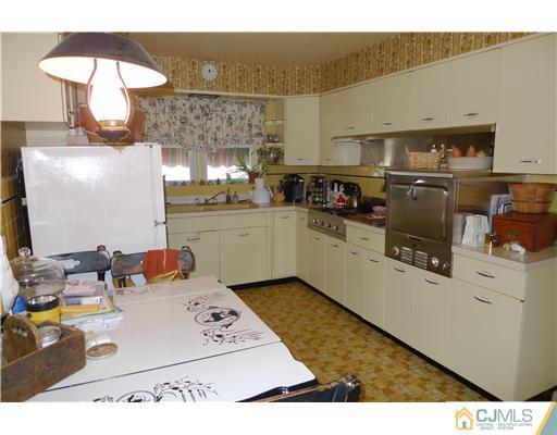 1707 River Road Belmar, NJ 07719 - Photo 5 of 17 a kitchen with a sink appliances and cabinets