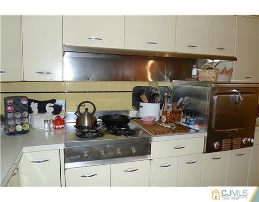 1707 River Road Belmar, NJ 07719 - Photo 6 of 17 a kitchen with a stove and cabinets