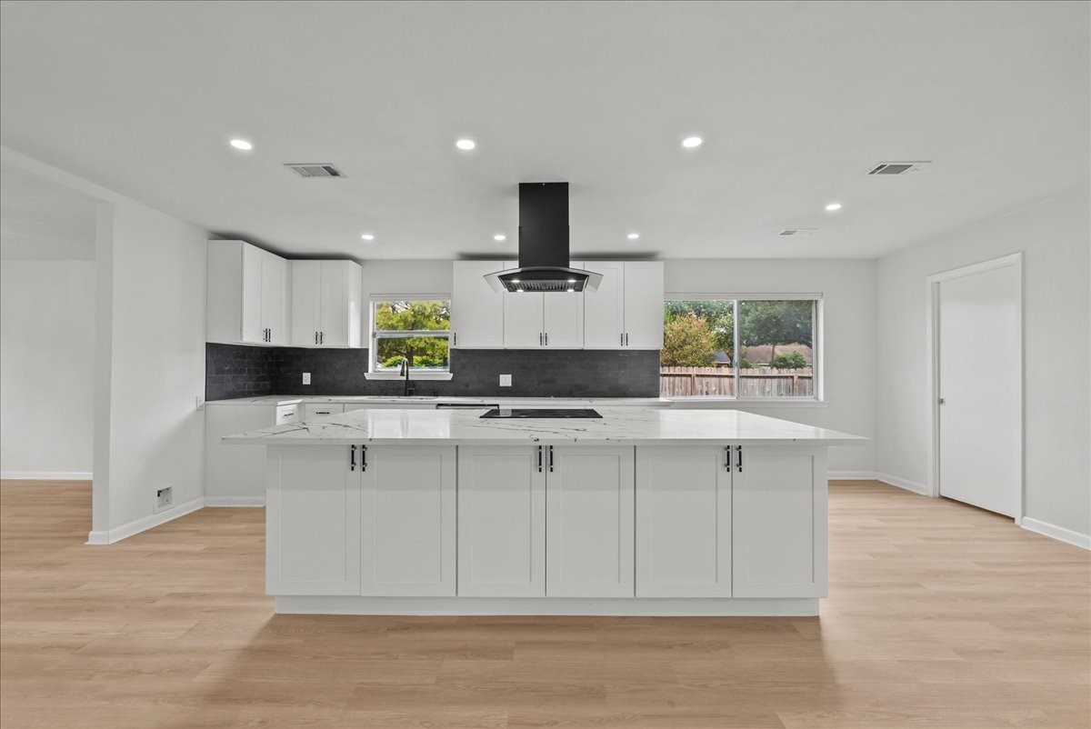 5762 Birdwood Road Houston, TX 77096 - Photo 10 of 50 THE OVERSIZED QUARTZ ISLAND MAKES ENTERTAINING A BREEZE.
