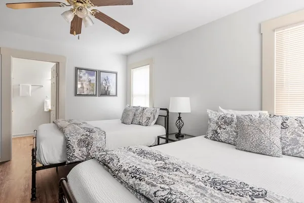 a bedroom with a bed and ceiling fan