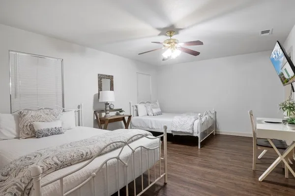 a bedroom with two beds and a table