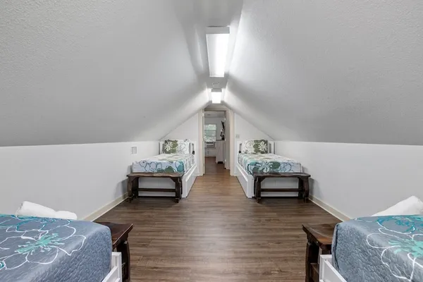 a bedroom with furniture and wooden floor