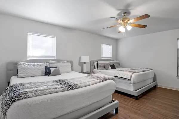 a bedroom with a large bed and a chandelier