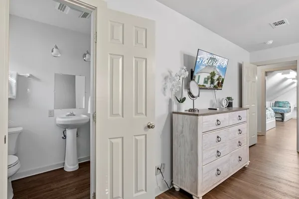 wooden floor with white cabinets and wooden floor