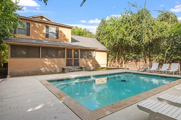 a view of a house with pool table and chairs