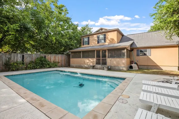 a view of a house with swimming pool and sitting area