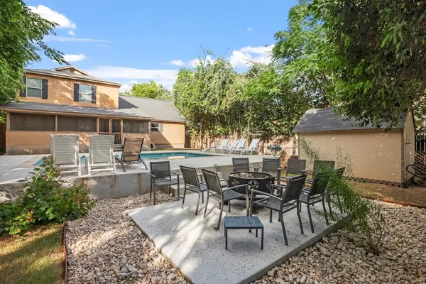 a view of a patio with table and chairs and potted plants