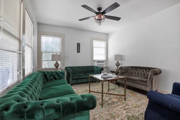 a living room with furniture and a large window