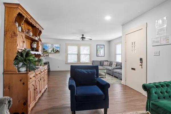 a living room with furniture and wooden floor