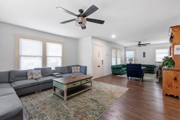 a living room with furniture and wooden floor