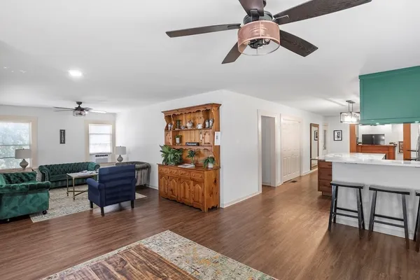 a living room with furniture and wooden floor