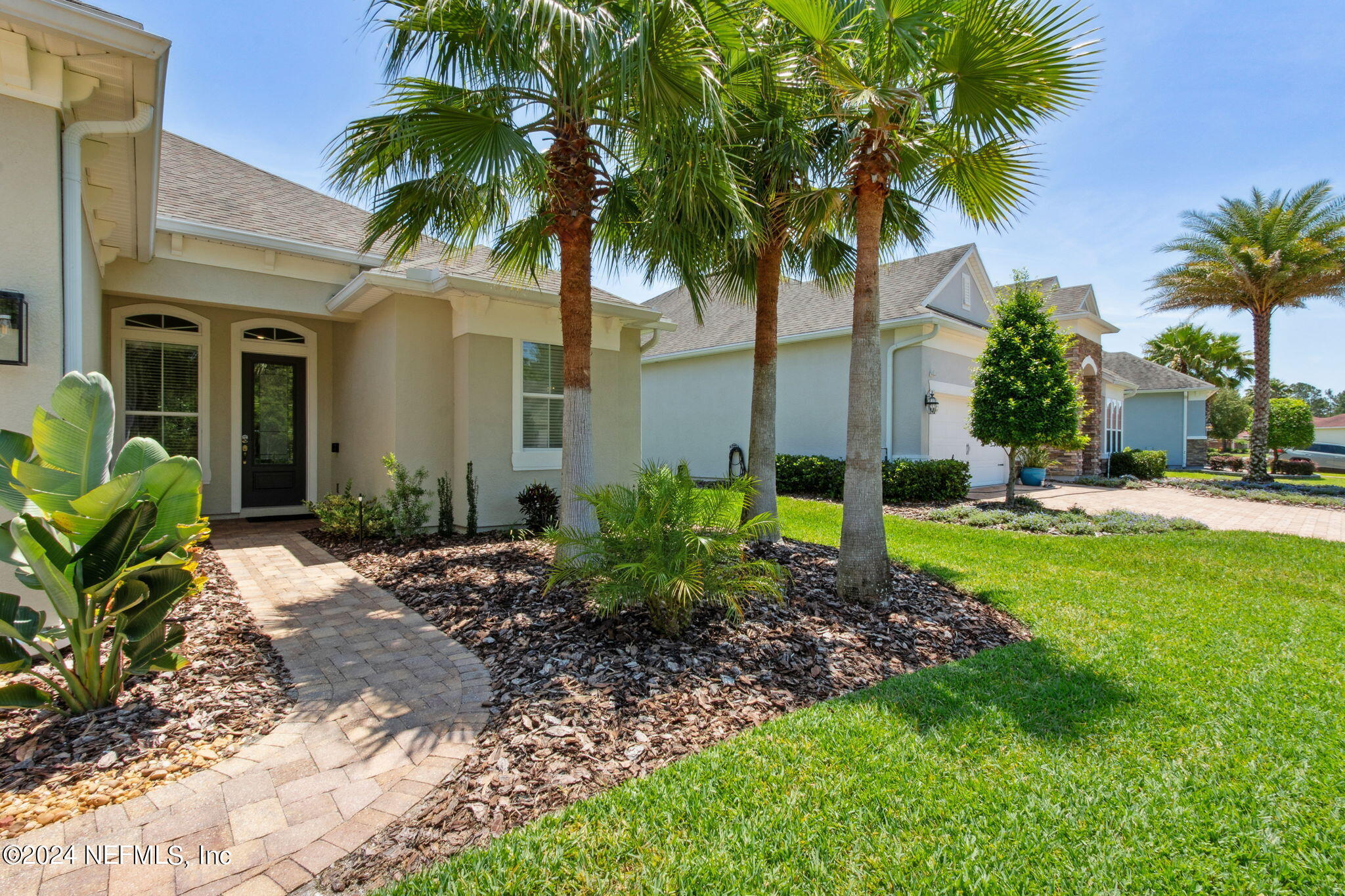 369 Medio Drive St. Augustine, FL 32095 - Photo 2 of 25 a couple of palm trees in front of yellow house
