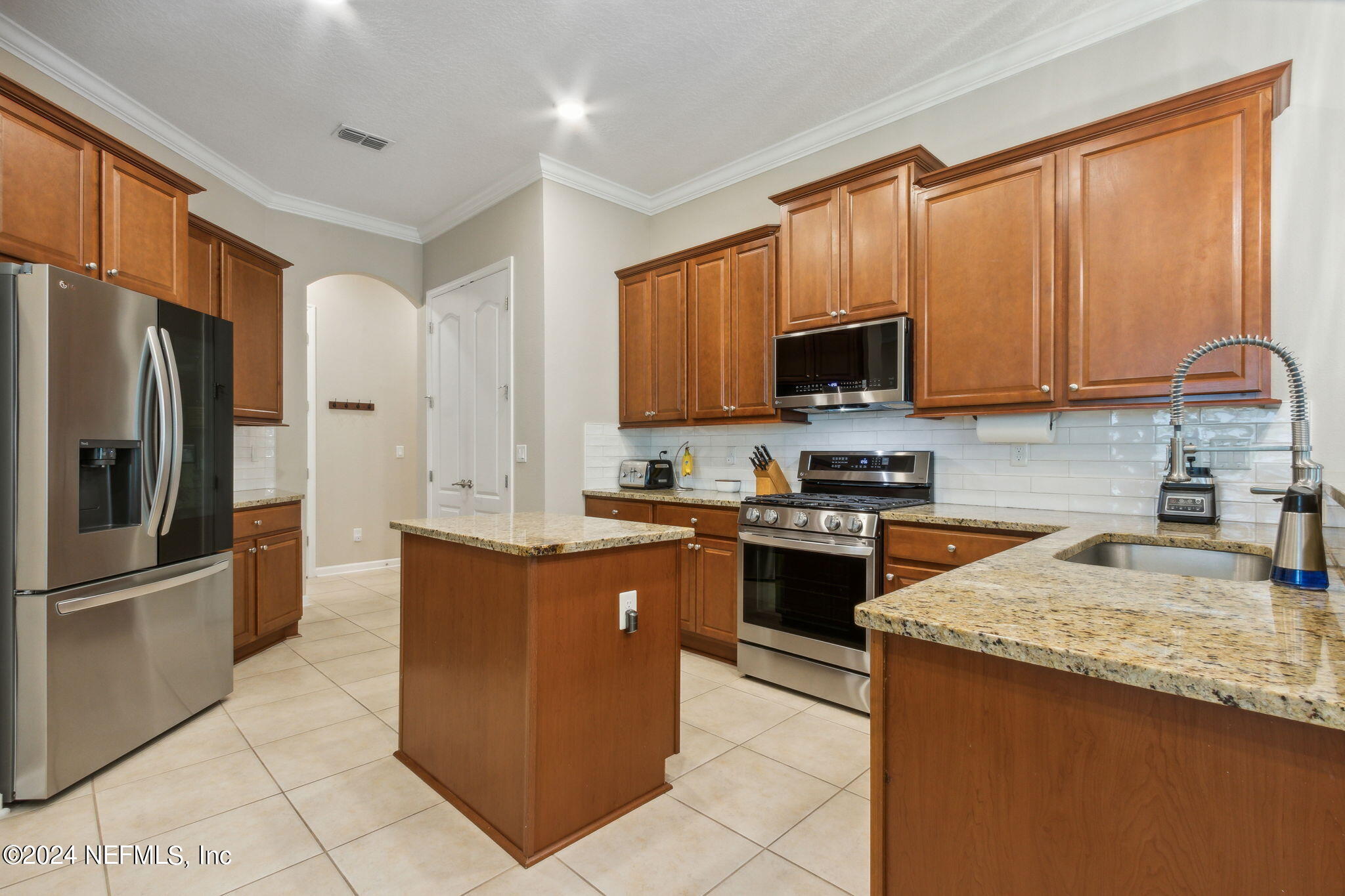 369 Medio Drive St. Augustine, FL 32095 - Photo 8 of 25 a kitchen with stainless steel appliances granite countertop a stove a sink dishwasher a refrigerator and a microwave oven