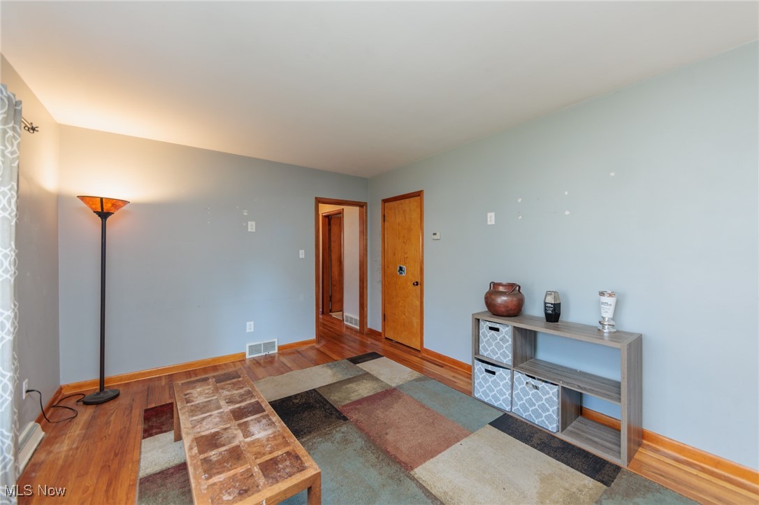 3801 Baird Road Stow, OH 44224 - Photo 5 of 31 Living room featuring wood finished floors and baseboards