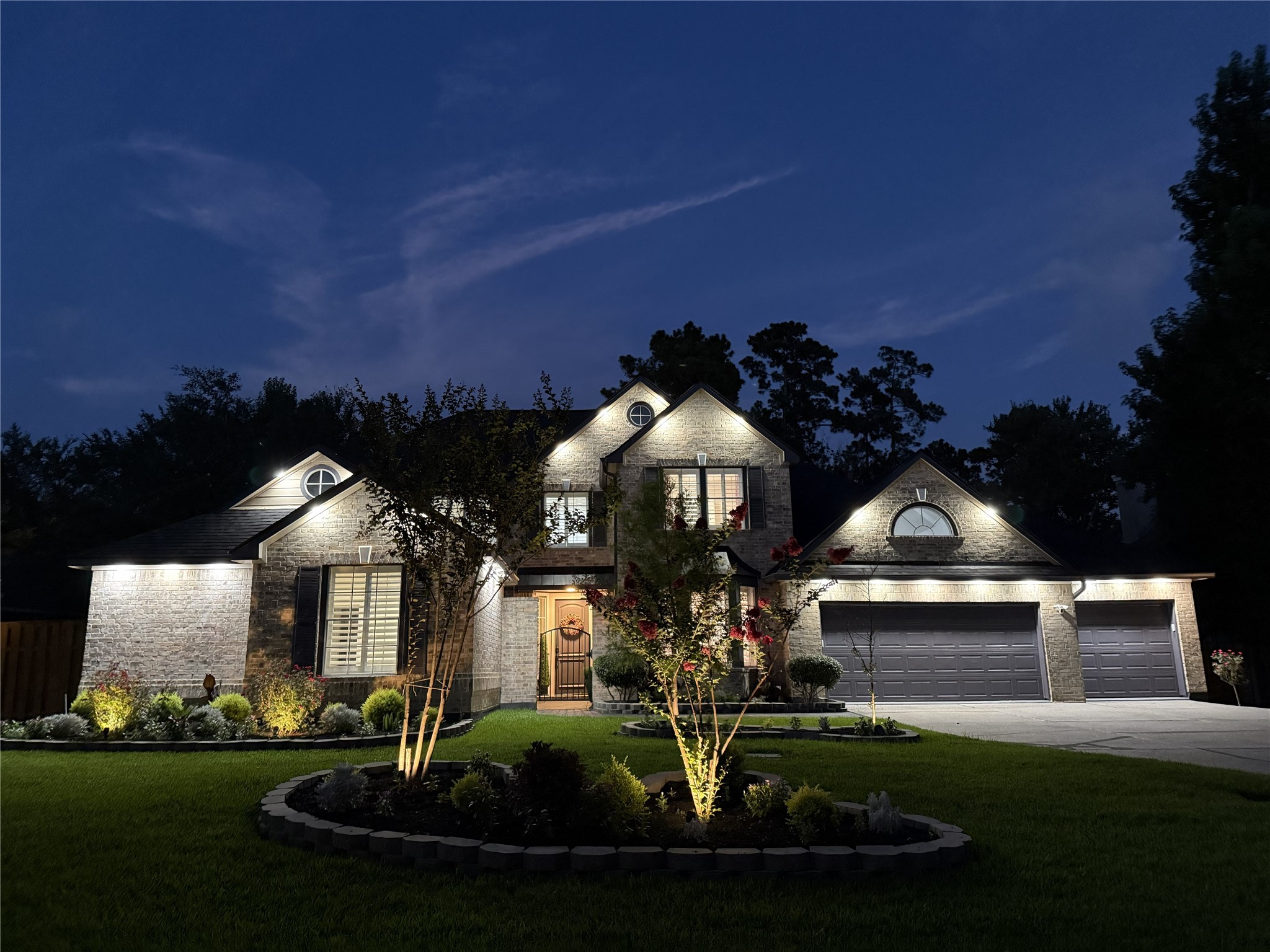 15 West Beckonvale Circle The Woodlands, TX 77382 - Photo 2 of 44 A stunning front elevation view at dusk! This home is equipped with extensive outdoor accent lighting!