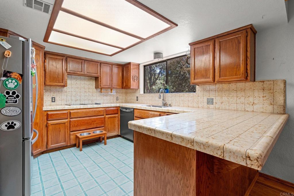 5041 Pine Ridge Avenue Julian, CA 92036 - Photo 11 of 27 a kitchen with a sink stove and cabinets