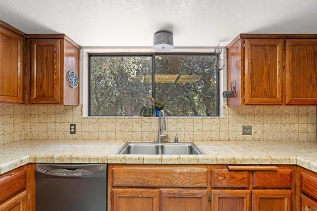 a kitchen with granite countertop a sink and a window