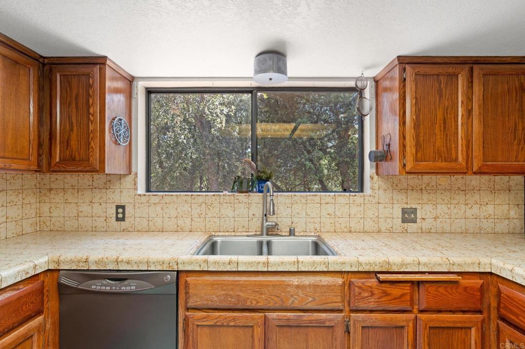 5041 Pine Ridge Avenue Julian, CA 92036 - Photo 12 of 27 a kitchen with granite countertop a sink and a window