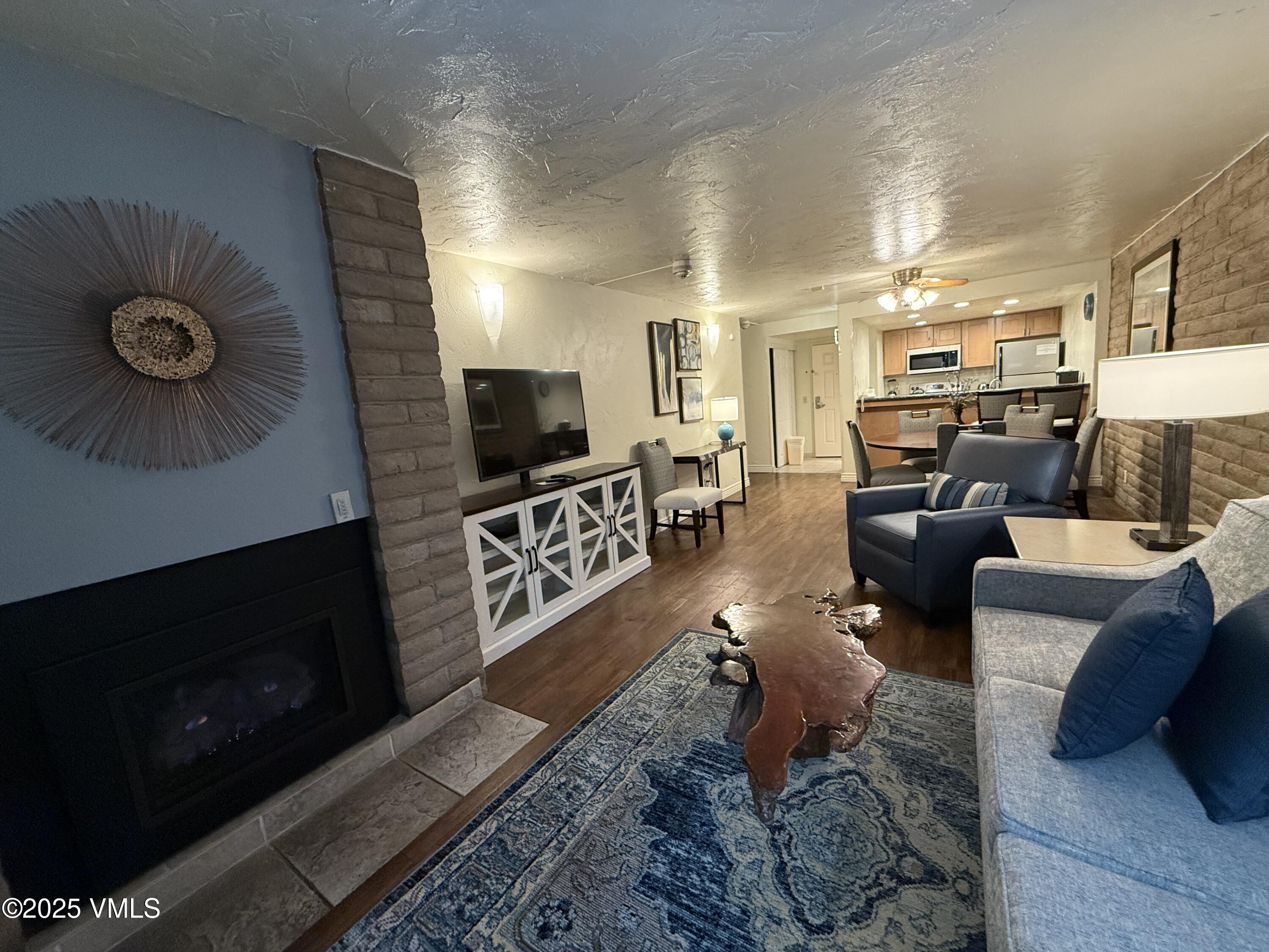 1020 Vail View Drive, Unit 321215 Vail, CO 81657 - Photo 4 of 23 a living room with furniture and a fireplace