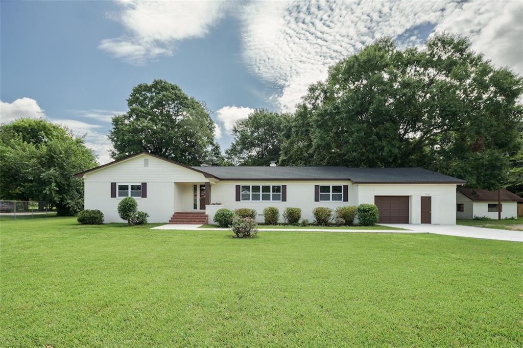 5762 Houston Road Macon, GA 31216 - Photo 1 of 1 a view of a house with a yard and trees