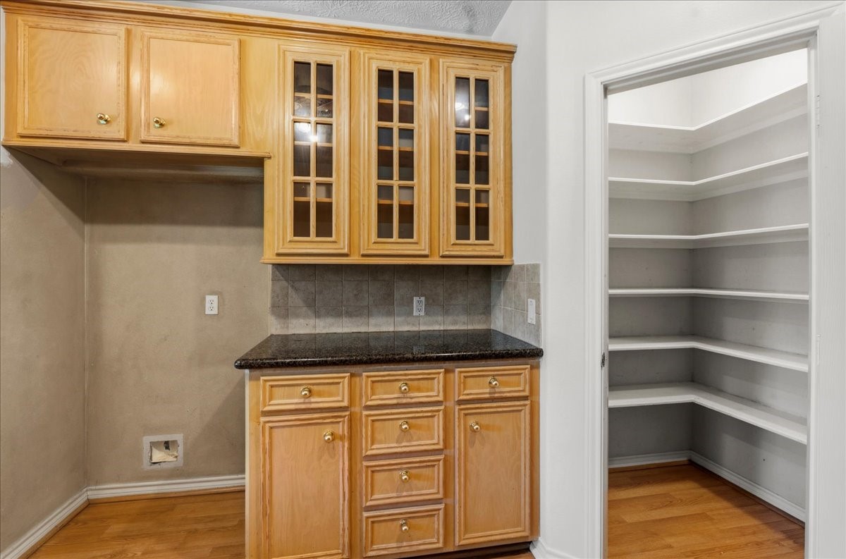 1607 Delta Lane Baytown, TX 77523 - Photo 19 of 48 The glass front cabinets on this wall are a beautiful detail.