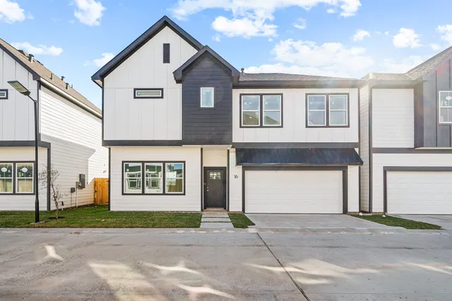 a view of a house with a yard and garage