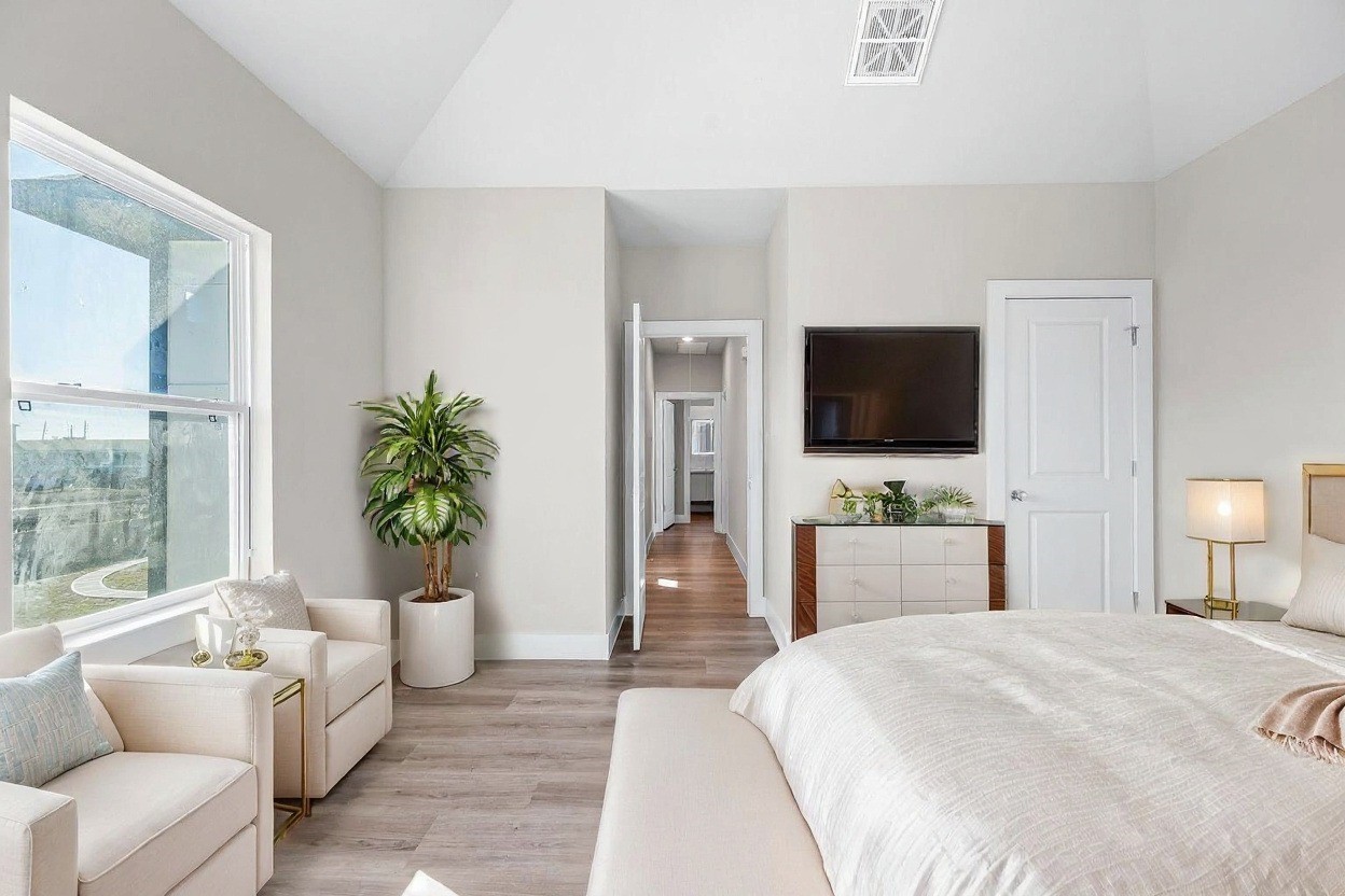 6702 Metro Boulevard, Unit 16 Houston, TX 77083 - Photo 19 of 49 a bedroom with a bed and a flat screen tv