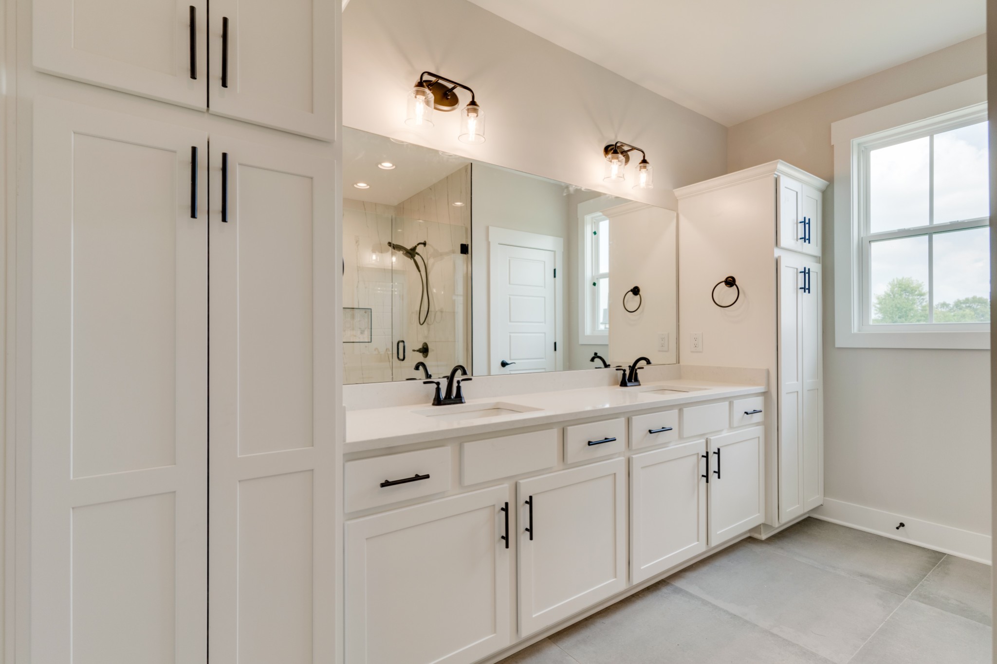 5046 Mt Zion Road Springfield, TN 37172 - Photo 13 of 28 a spacious bathroom with a double vanity sink a large mirror a shower and window