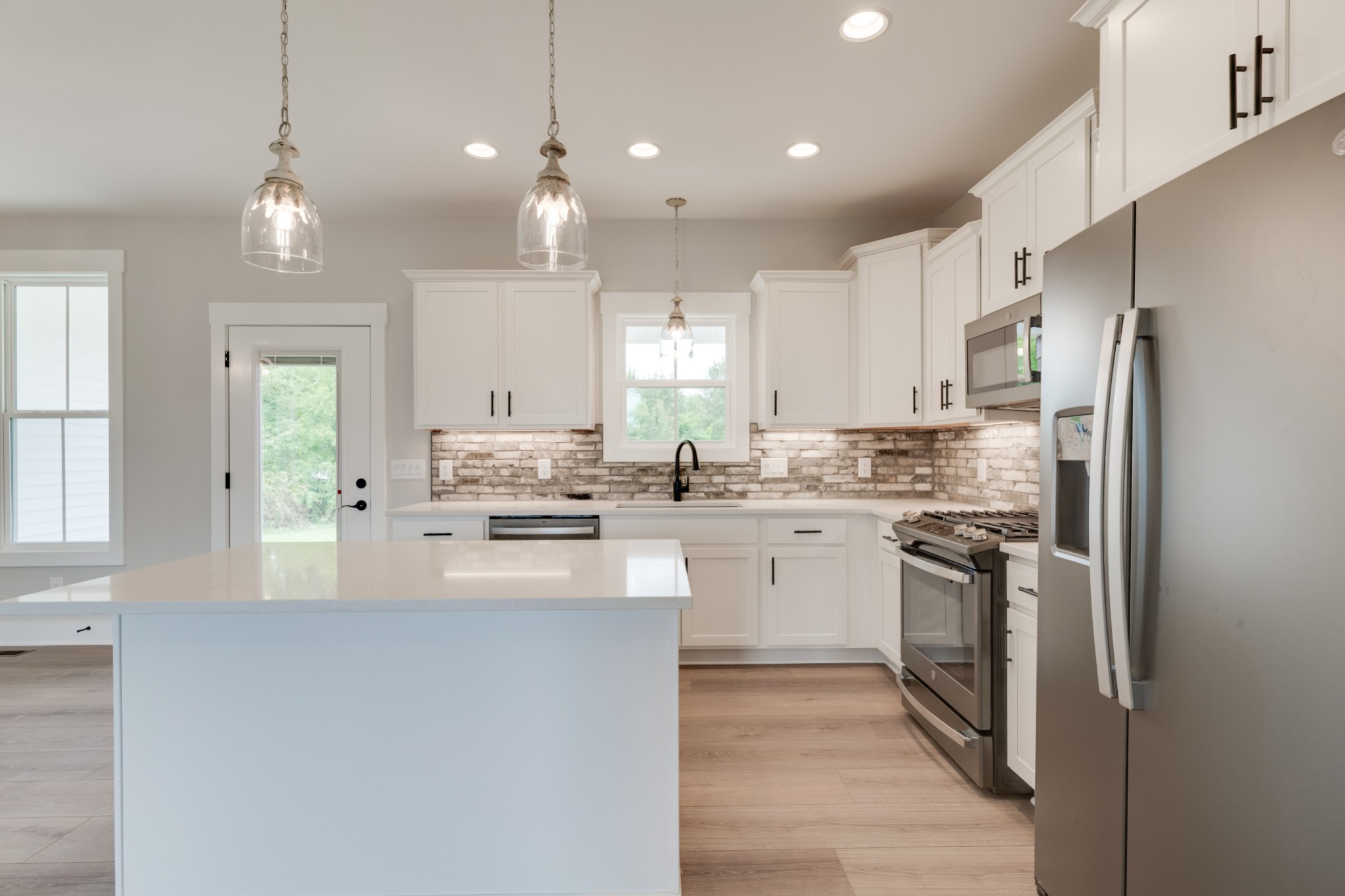 5046 Mt Zion Road Springfield, TN 37172 - Photo 8 of 28 a kitchen with kitchen island white cabinets and stainless steel appliances