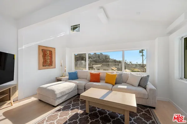 a bedroom with furniture and a flat screen tv