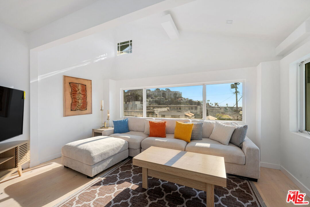 a bedroom with furniture and a flat screen tv
