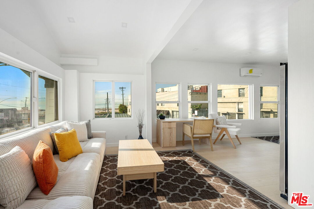 117 West Channel Road, Unit 119 Santa Monica, CA 90402 - Photo 4 of 10 a living room with furniture and a large window