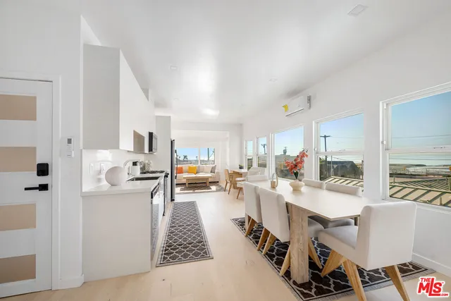 a large white kitchen with stainless steel appliances