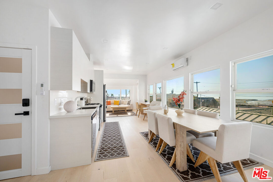 117 West Channel Road, Unit 119 Santa Monica, CA 90402 - Photo 5 of 10 a large white kitchen with stainless steel appliances
