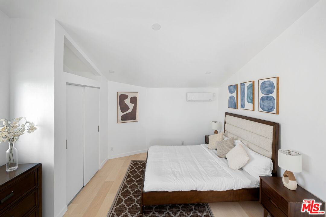 117 West Channel Road, Unit 119 Santa Monica, CA 90402 - Photo 6 of 10 a bedroom with a bed and a night stand