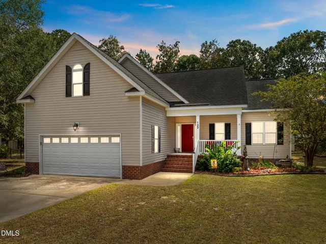 a front view of a house with a yard and garage