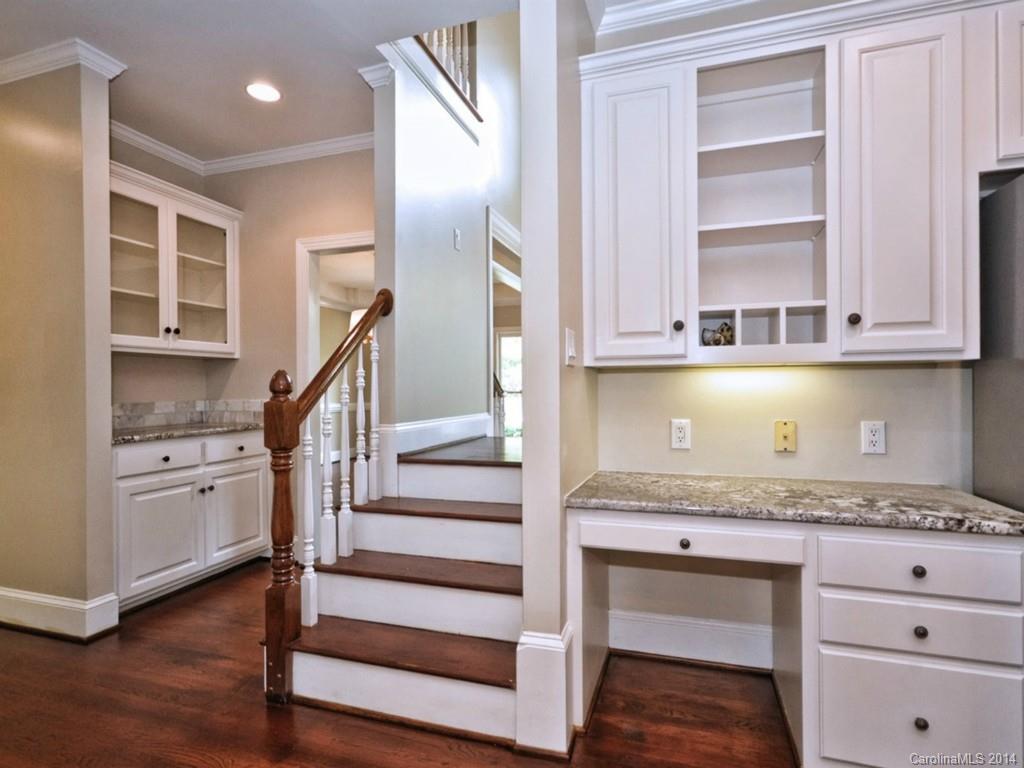 13504 Scanlan Way Davidson, NC 28036 - Photo 12 of 23 a kitchen with granite countertop a stove and cabinets