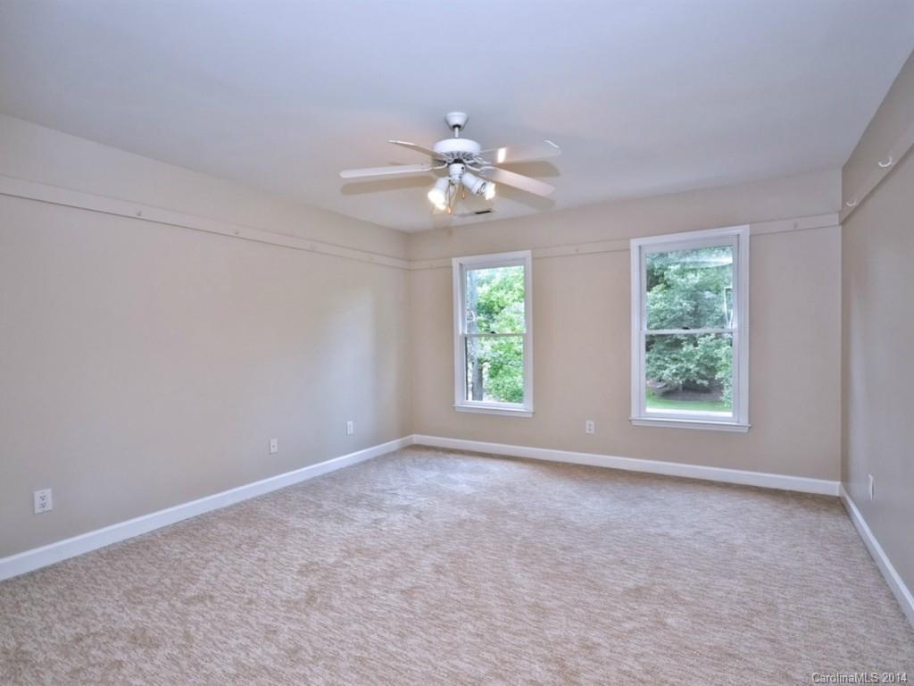 13504 Scanlan Way Davidson, NC 28036 - Photo 15 of 23 an empty room with windows and chandelier fan