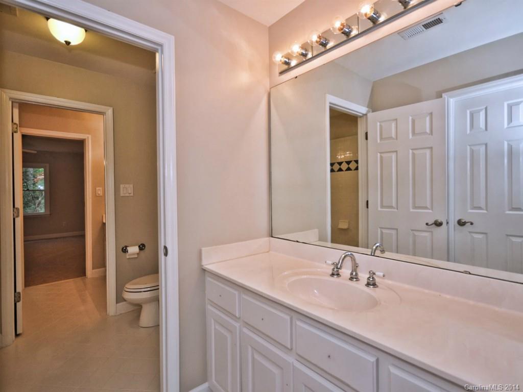 13504 Scanlan Way Davidson, NC 28036 - Photo 16 of 23 a bathroom with a double vanity sink and a mirror